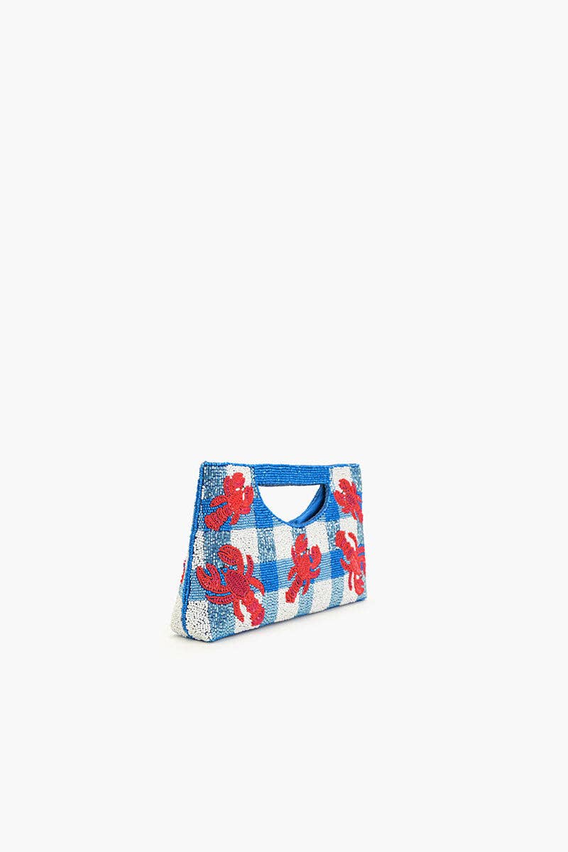 angled view of red sequin lobster theme bag and blue and white beaded detail against a white background