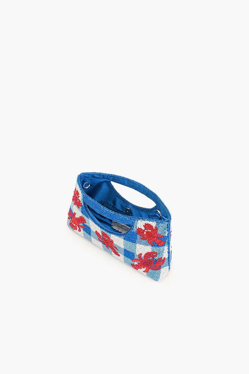 red sequin lobsters on a blue and white beaded bag against a white background