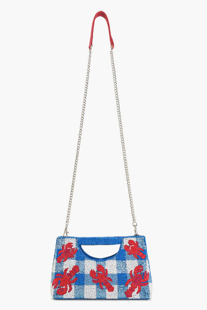 red sequin lobsters on a blue and white beaded bag with silver chain against a white background