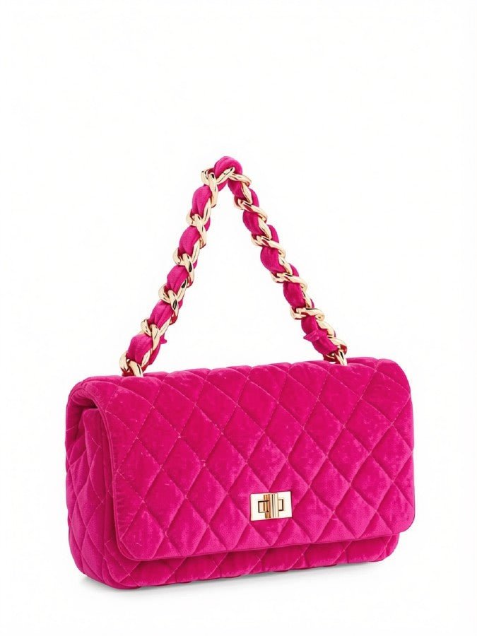 A bright pink quilted velvet shoulder bag with a gold-tone chain handle and a small gold turn-lock clasp on a white background.