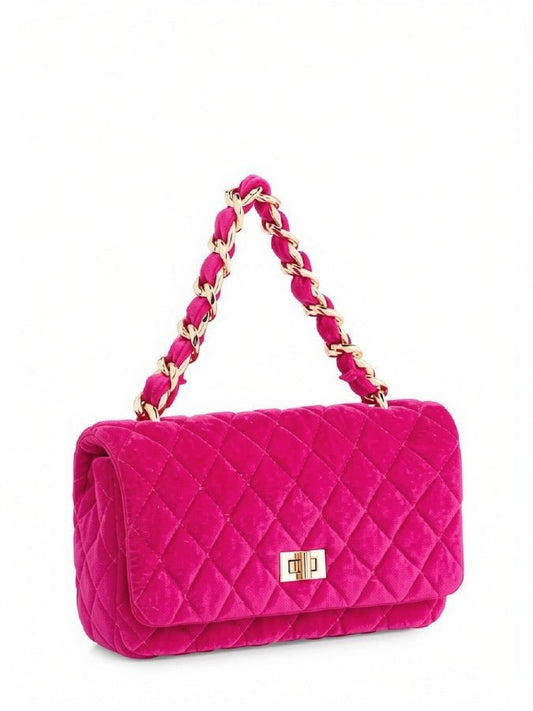 A bright pink quilted velvet shoulder bag with a gold-tone chain handle and a small gold turn-lock clasp on a white background.
