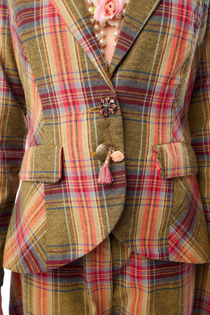 Up close view of plaid suit jacket with floral details to show crystal button detailing on a person