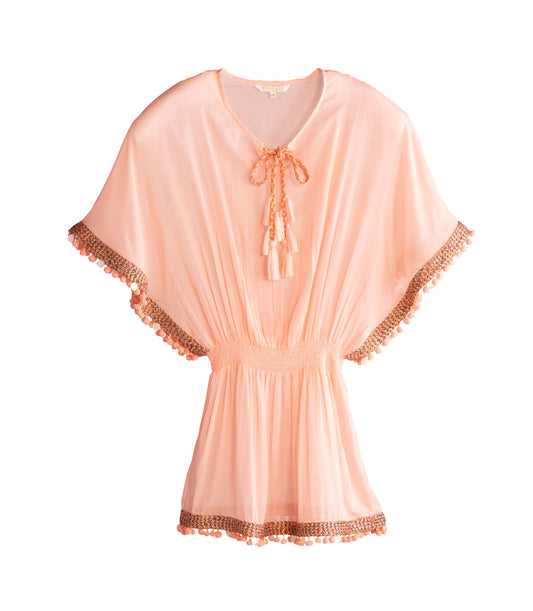 A pink cover-up with short sleeves, a tie at the neck, and tassel detailing at the hem against a white background