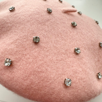 side view of light pink beret covered in rhinestone studs