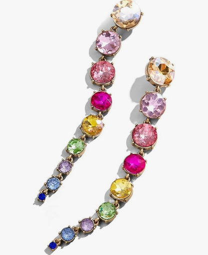a pair of rainbow crystal drop earrings with round cubic zirconia stones against a white background