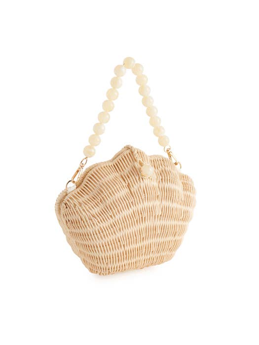 Rattan shell bag with pearl-beaded handle and gold hardware — front angled view showing shell silhouette and woven rattan texture