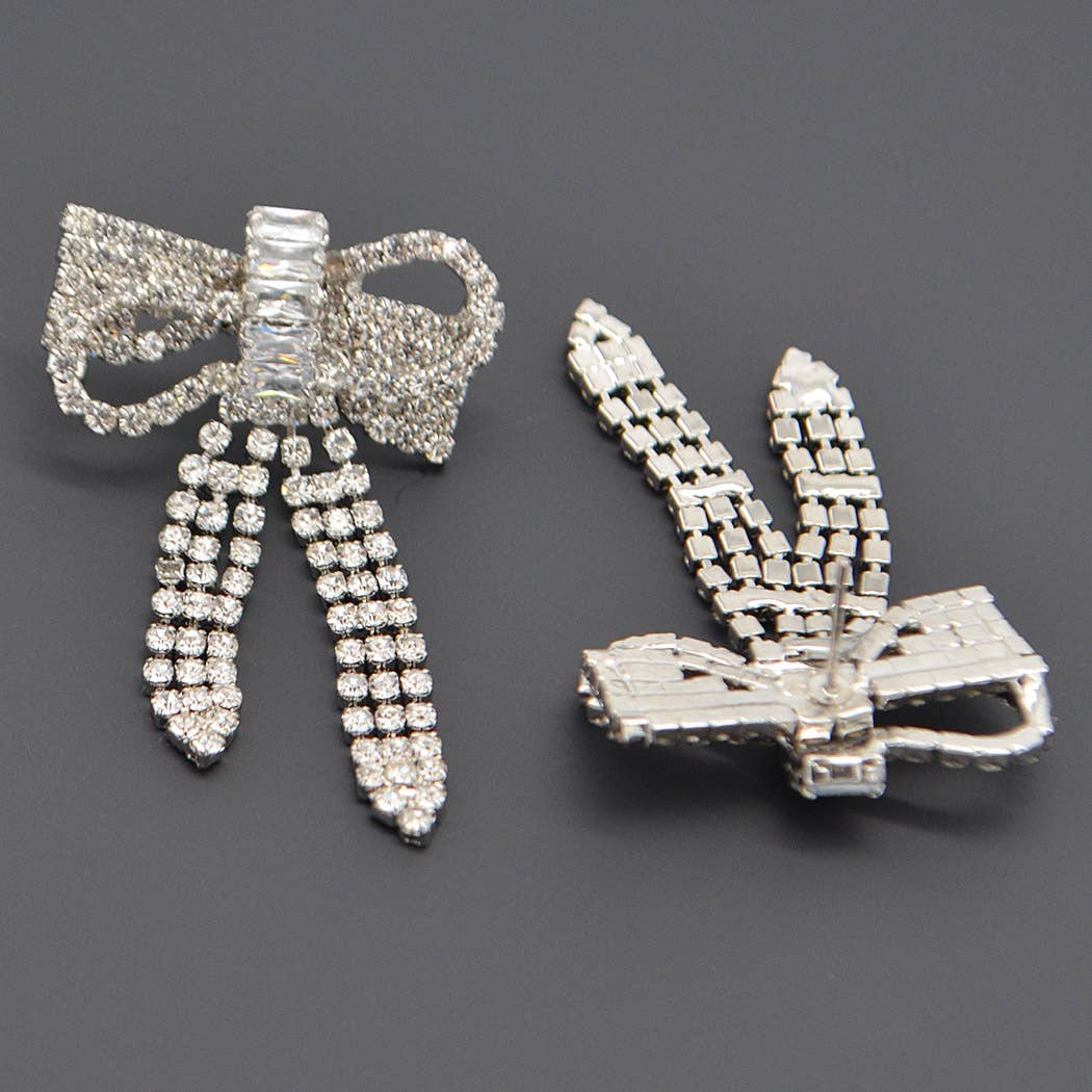 a pair of ribbon shaped rhinestone earrings showing one from the front and one from the back