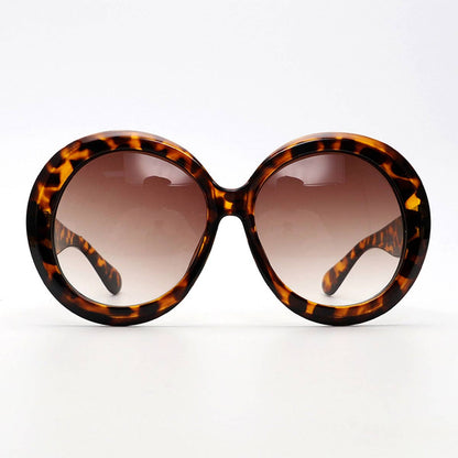 Tortoiseshell sunglasses with brown gradient lenses on a white background