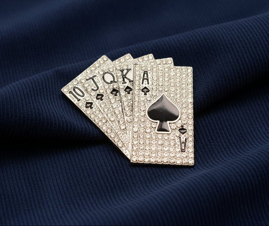 crystal royal flush playing cards brooch on a navy blue corduroy fabric background