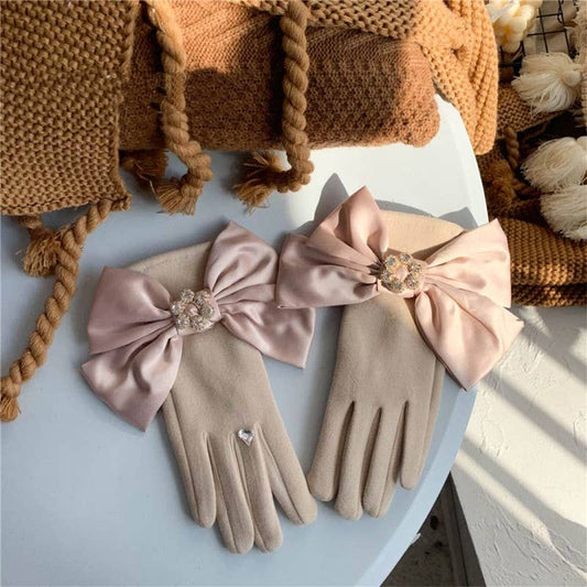 a pair of gloves with satin bow and crystal embellishment