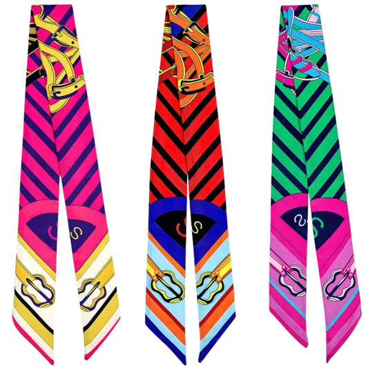 Three colorful scarf twillies with geometric patterns on a white background