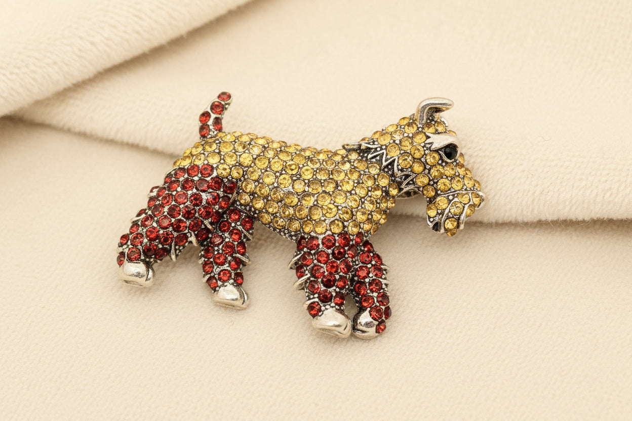 crystal encrusted schnauzer dog brooch against a grey background