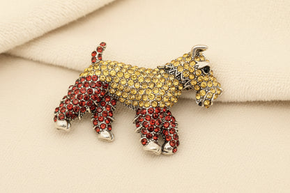 crystal encrusted schnauzer dog brooch against a grey background