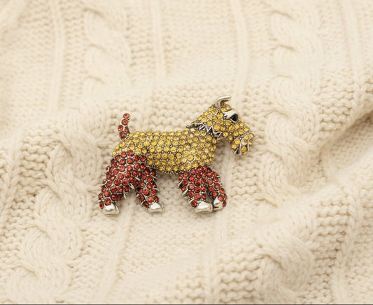 schnauzer crystal dog shaped brooch on an ivory sweater material