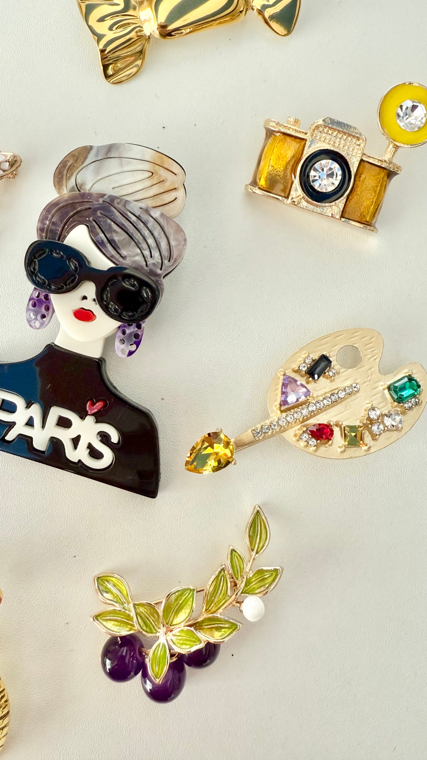 Collection of colorful brooches on a light background