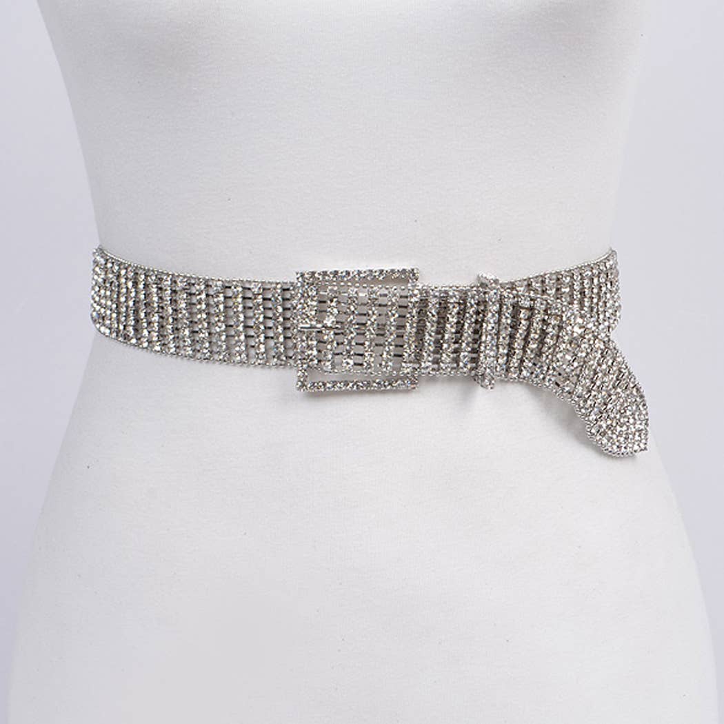 An adjustable rhinestone belt displayed on a mannequin, with the belt featuring a shiny silver color and a buckle closure.