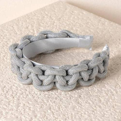 silver braided headband against an ivory textured background