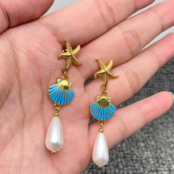 gold starfish shell earrings with blue enamel clam and pearl drop coastal jewelry
