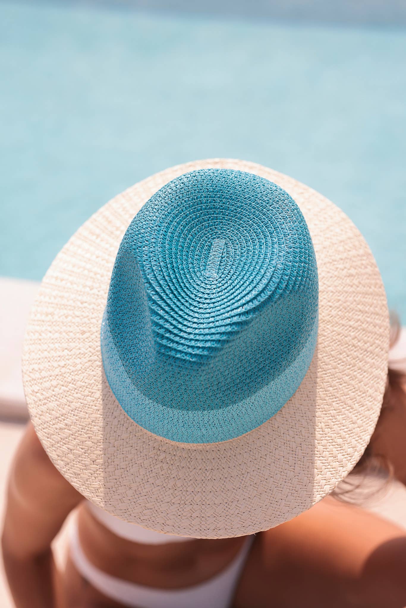 close-up of turquoise woven straw crown on wide brim sun hat